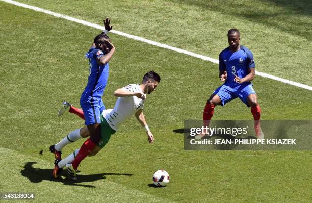 Ireland's forward Shane Long is challenged by y France's midfielder Paul Pogba as France's defender Patrice Evra gestures during the Euro 2016 round...