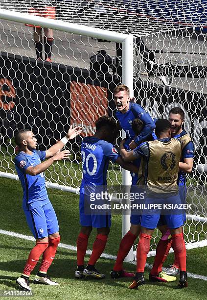 France's forward Antoine Griezmann celebrates scoring a second goal with team mates during the Euro 2016 round of 16 football match between France...