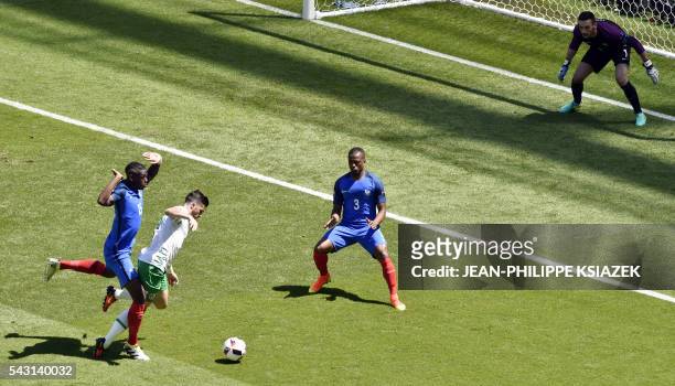 Ireland's forward Shane Long is challenged by France's midfielder Paul Pogba during the Euro 2016 round of 16 football match between France and...