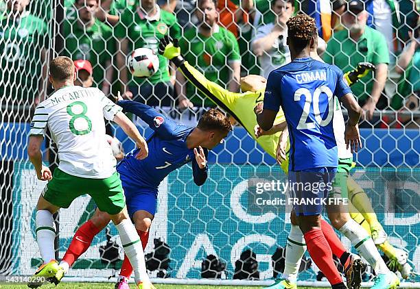 France's forward Antoine Griezmann heads the ball to score against Ireland's goalkeeper Darren Randolph during the Euro 2016 round of 16 football...