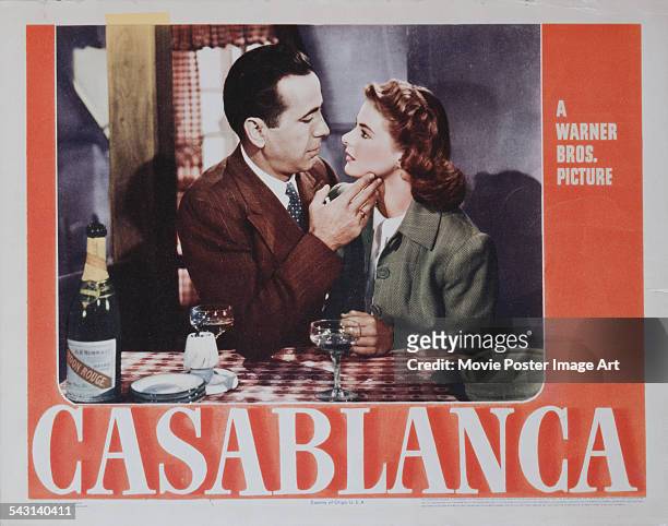 Actors Humphrey Bogart and Ingrid Bergman fall in love on a poster for the Warner Bros. Film 'Casablanca', 1942.