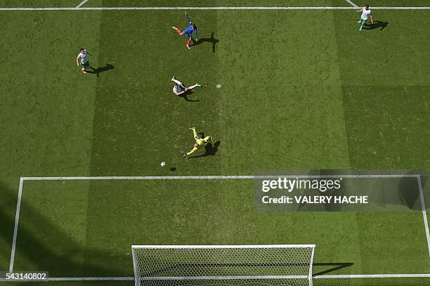 France's forward Antoine Griezmann scores against Ireland's goalkeeper Darren Randolph during the Euro 2016 round of 16 football match between France...