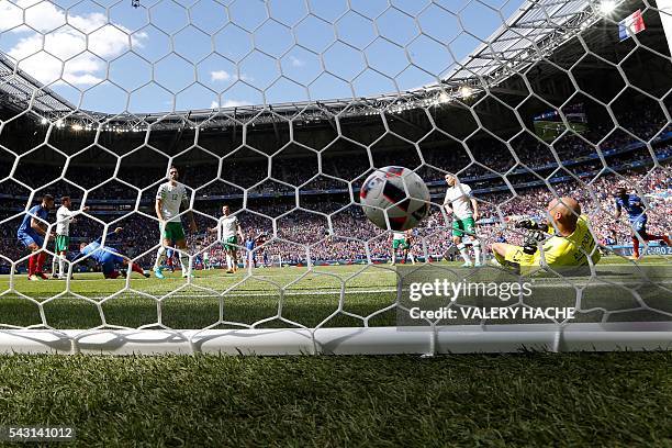 France's forward Antoine Griezmann scores a first goal past Ireland's goalkeeper Darren Randolph during the Euro 2016 round of 16 football match...