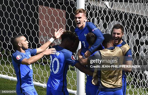 France's forward Antoine Griezmann celebrates scoring a second goal with team mates during the Euro 2016 round of 16 football match between France...