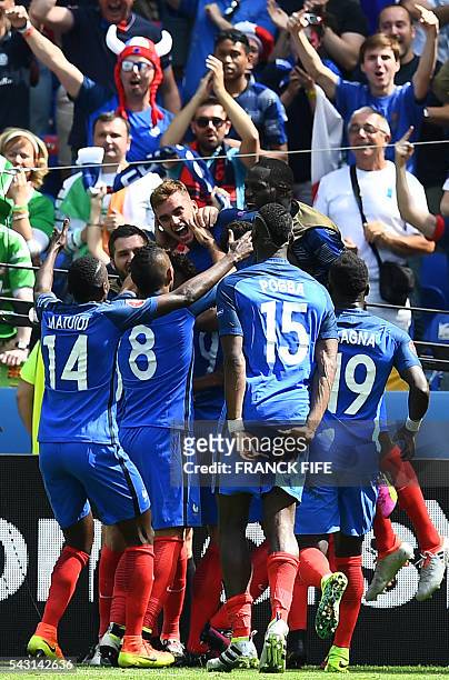 France's forward Antoine Griezmann celebrates with teammates after he scored during the Euro 2016 round of 16 football match between France and...