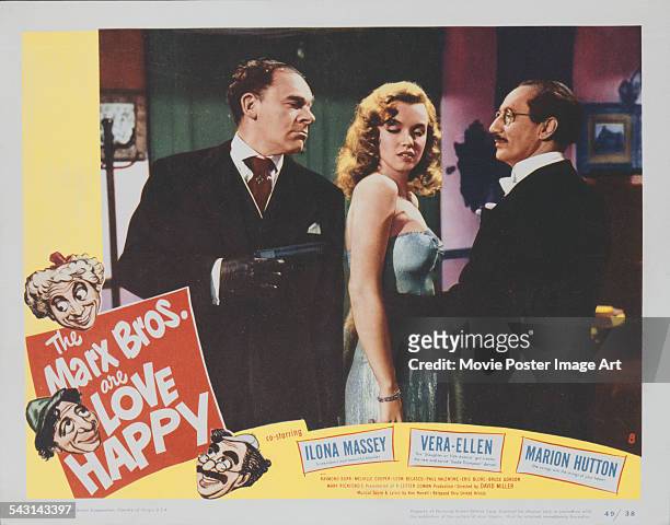 From left to right, actors Raymond Burr, Marilyn Monroe and Groucho Marx appear on the poster for the Marx Brothers film 'Love Happy', 1949.