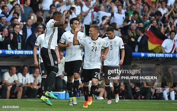 Germany's defender Jerome Boateng celebrates with Germany's midfielder Joshua Kimmich after scoring during Euro 2016 round of 16 football match...