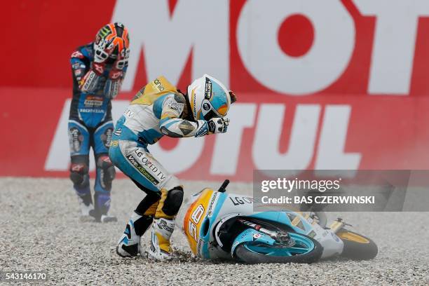 Spanish rider Juanfran Guevara of Mapfre Team Mahindra Moto3 and Spanish rider Aron Canet of Honda Estrella Galicia team react after crashing during...