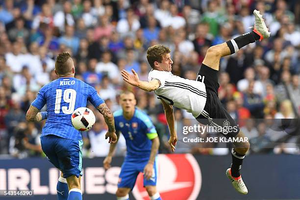 Germany's midfielder Thomas Mueller challenges Slovakia's midfielder Juraj Kucka during the Euro 2016 round of 16 football match between Germany and...