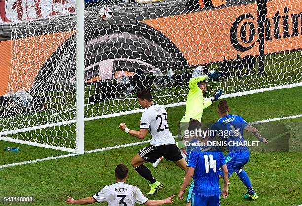 Germany's forward Mario Gomez scores against Slovakia's goalkeeper Matus Kozacik during the Euro 2016 round of 16 football match between Germany and...