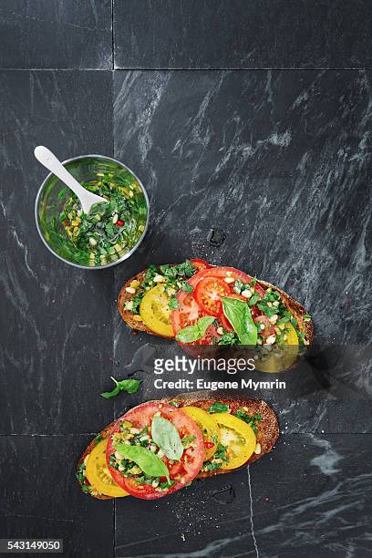 tomato, harissa and green olive bruschetta - bruschetta stock pictures, royalty-free photos & images