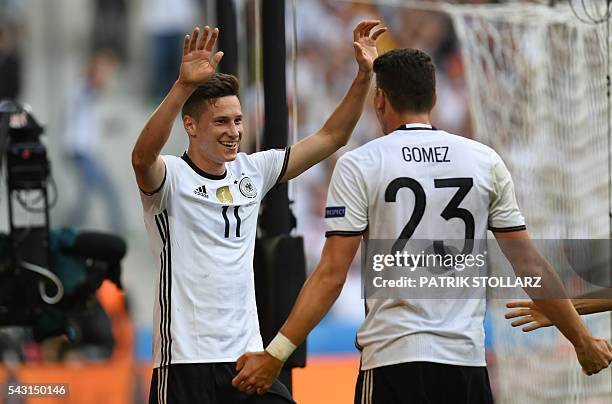 Germany's forward Mario Gomez celebrates with Germany's midfielder Julian Draxler after scoring a goal during the Euro 2016 round of 16 football...