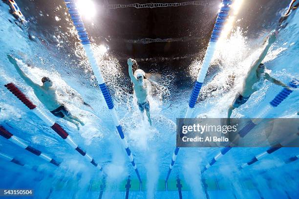 Clark Smith, Connor Jaeger and Conor Dwyer of the United States compete in a preliminary heat for the Men's 400 Meter Freestyle during Day One of the...