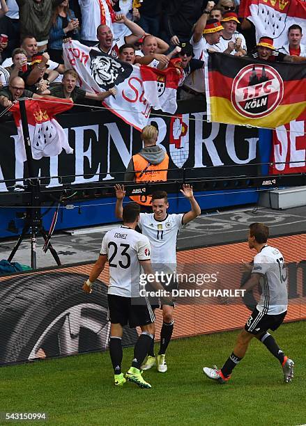 Germany's forward Mario Gomez celebrates with teammates after scoring during the Euro 2016 round of 16 football match between Germany and Slovakia at...