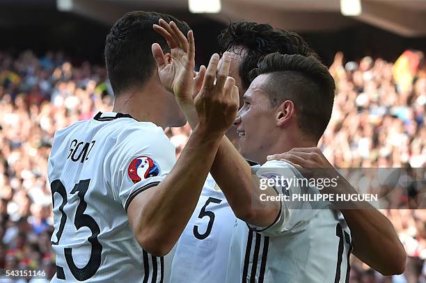 Germany's midfielder Julian Draxler celebrates with teammates after scoring during the Euro 2016 round of 16 football match between Germany and...