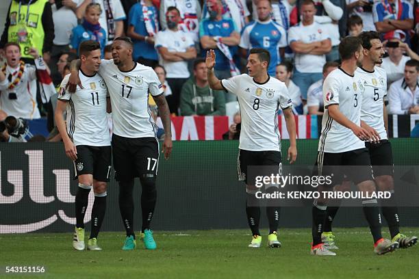 Germany's midfielder Julian Draxler celebrates with teammates after scoring their third goal during the Euro 2016 round of 16 football match between...