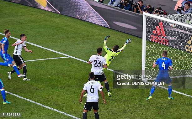 Germany's midfielder Julian Draxler scores against Slovakia's goalkeeper Matus Kozacik during the Euro 2016 round of 16 football match between...
