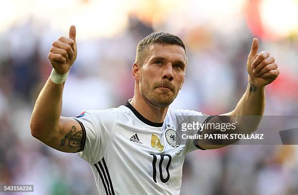 Germany's forward Lukas Podolski celebrates at the end of the Euro 2016 round of 16 football match between Germany and Slovakia at the Pierre-Mauroy...