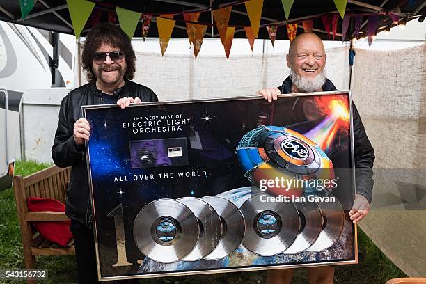 Jeff Lynne of ELO and Michael Eavis pose backstage with a commemorative disc for the album "All Over the World" on day 3 of the Glastonbury Festival...