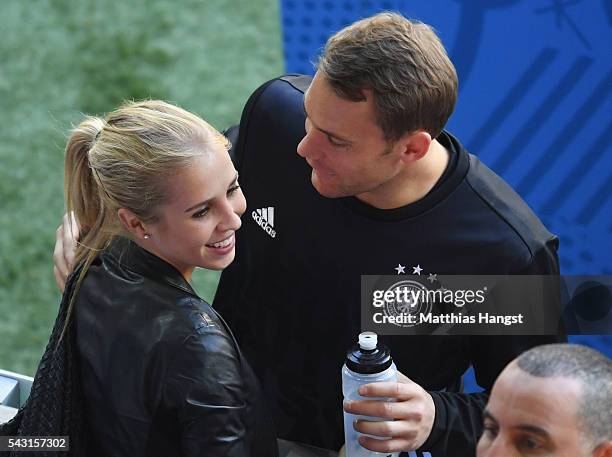 Manuel Neuer of Germany talks his girlfriend Nina Weiss after the UEFA EURO 2016 round of 16 match between Germany and Slovakia at Stade...