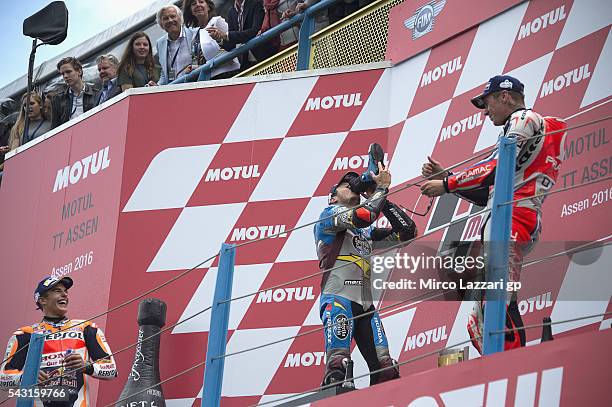 Jack Miller of Australia and Marc VDS Racing Team drinks champagne from the boot and celebrates on the podium his first victory on the MotoGP race at...