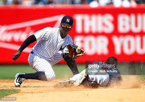 Shortstop Didi Gregorius of the New York Yankees gets set to tag out Eduardo Nunez of the Minnesota Twins who attempted to steal second base in the...