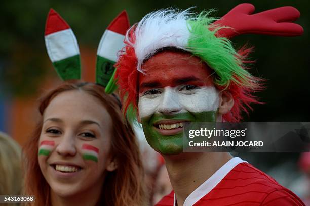 Hungary's supporters react as they watch on a giant screen the Euro 2016 round of 16 football match between Hungary and Belgium at the Champs-de-Mars...