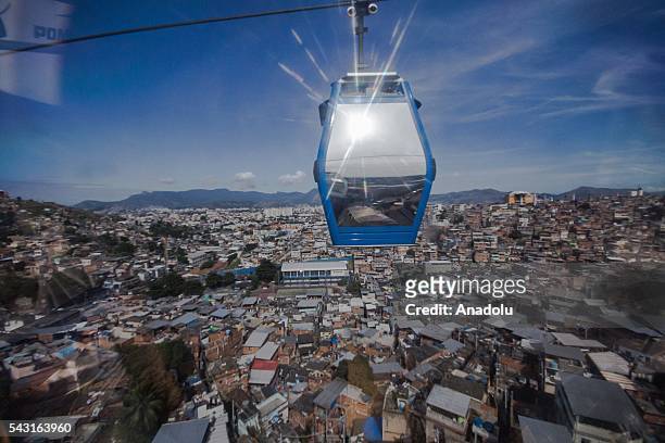 Cable car transports commuters over homes in the Alemao Complex, Morro do Alemao is seen in Rio de Janeiro, Brazil on June 26, 2016.