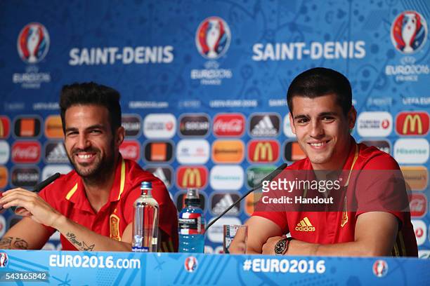 In this handout image provided by UEFA Alvaro Morata and Cesc Fabregas of Spain attend a press conference at Stade de France on June 26, 2016 in...