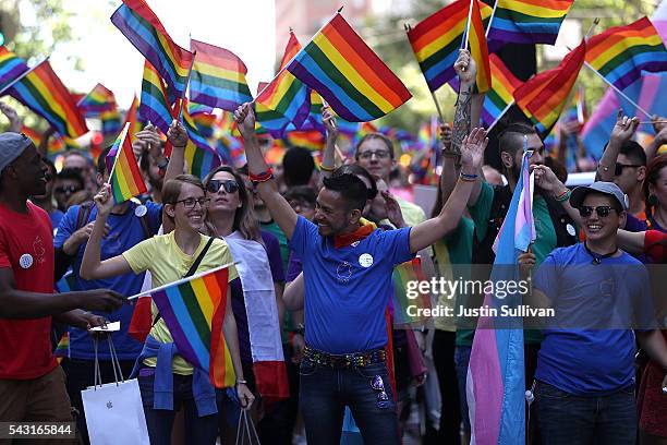 Parade participants wave pride flags as the march during the 2016 San Francisco Pride Parade on June 26, 2016 in San Francisco, California. Hundreds...