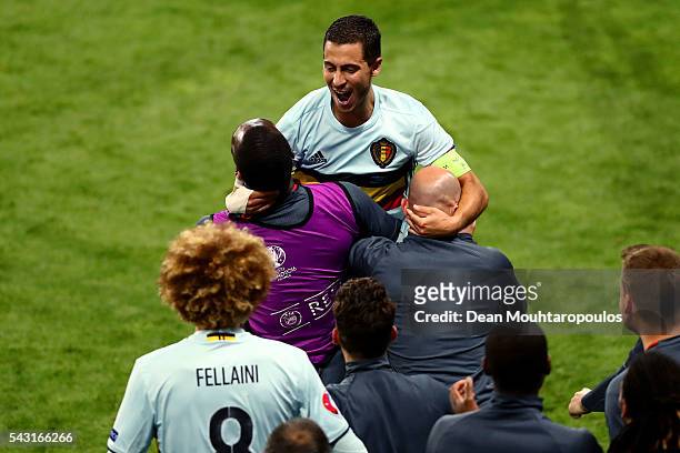 Eden Hazard of Belgium celebrates scoring his team's third goal with his team mates and staffs during the UEFA EURO 2016 round of 16 match between...