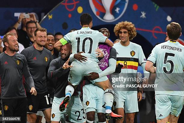 Belgium's forward Eden Hazard celebrates with teammates after scoring his team's third goal during the Euro 2016 round of 16 football match between...