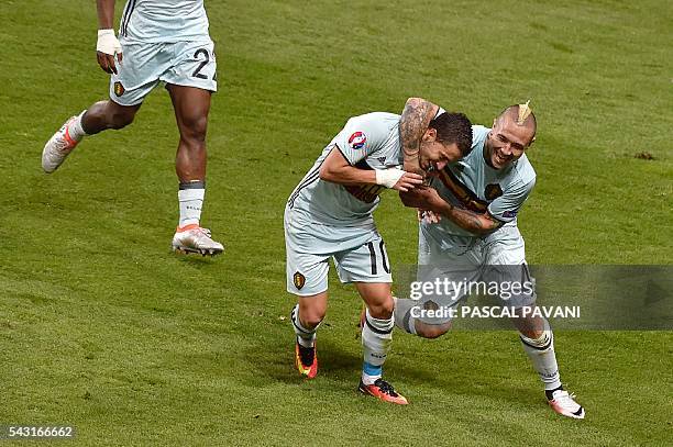 Belgium's forward Eden Hazard celebrates with Belgium's midfielder Radja Nainggolan after scoring his team's third goal during the Euro 2016 round of...