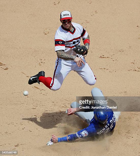 Brett Lawrie of the Chicago White Sox turns a double play over Josh Donaldson of the Toronto Blue Jays in the 7th inning at U.S. Cellular Field on...