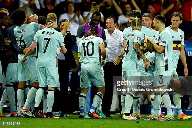 Eden Hazard of Belgium is congratulated by his team mate Christian Benteke and manager Marc Wilmots after scoring their team's third goal during the...