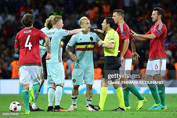 Belgium's midfielder Radja Nainggolan and Belgium's midfielder Kevin De Bruyne argue with Hungary's defender Richard Guzmics and Hungary's midfielder...