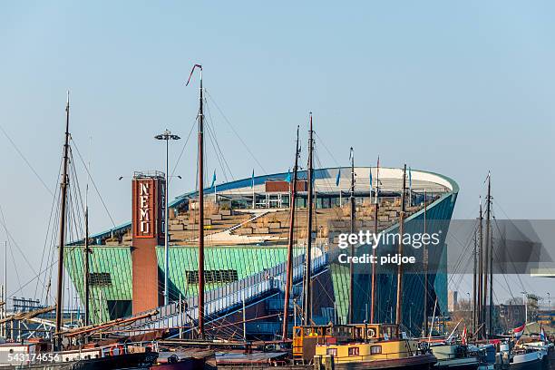 harbour of amsterdam with in the back the museum nemo - nemo stock pictures, royalty-free photos & images