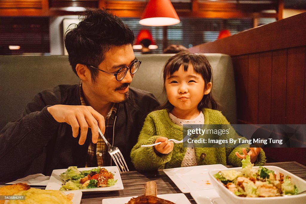 Dad & daughter enjoying meal in restaurant