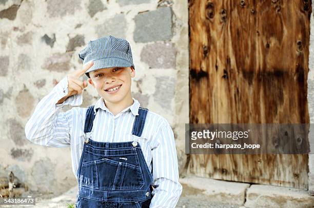 boy dressed up as a train engineer - kids costume engineer stock-fotos und bilder