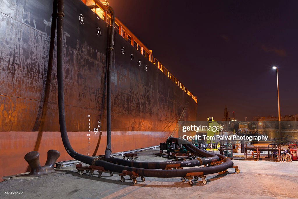 Oil tanker ship docked in industrial harbor