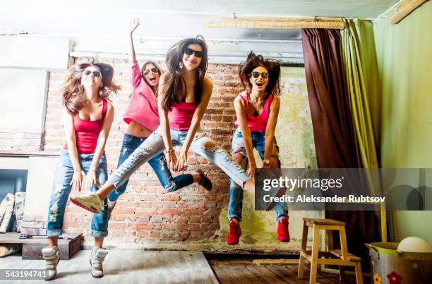 caucasian women jumping in living room - dancing funny carefree woman stock pictures, royalty-free photos & images