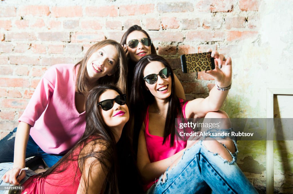 Caucasian women taking cell phone selfie