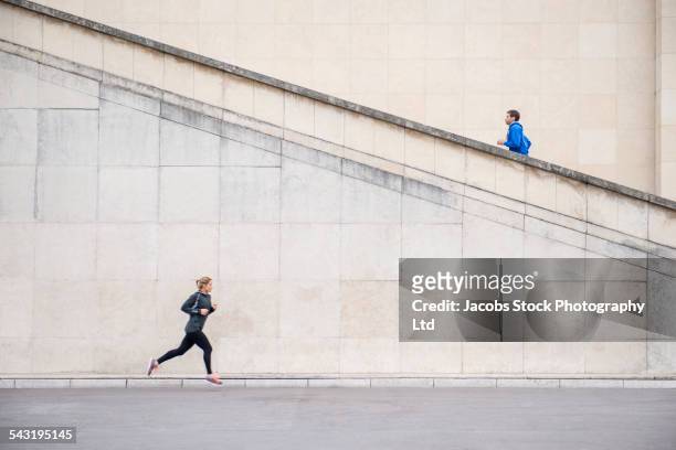 runners jogging near staircase - 2 steps foto e immagini stock