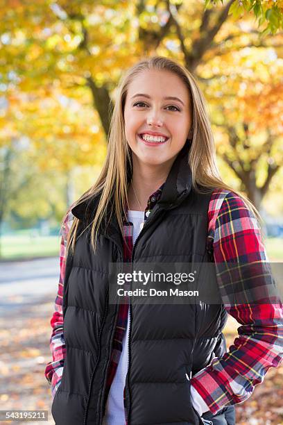 caucasian woman smiling in park - flannel shirt stock pictures, royalty-free photos & images