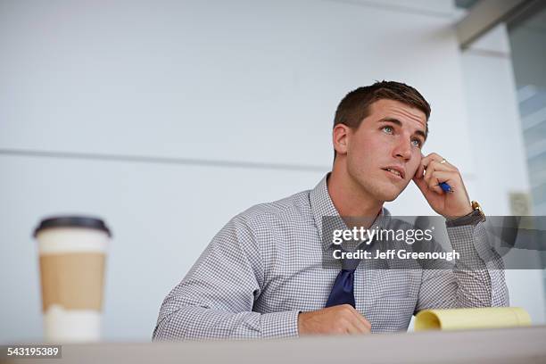 caucasian businessman sitting in office - blacksburg stock pictures, royalty-free photos & images