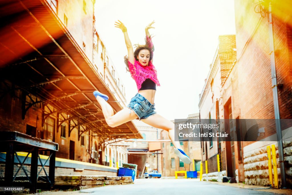 Caucasian woman dancing in street