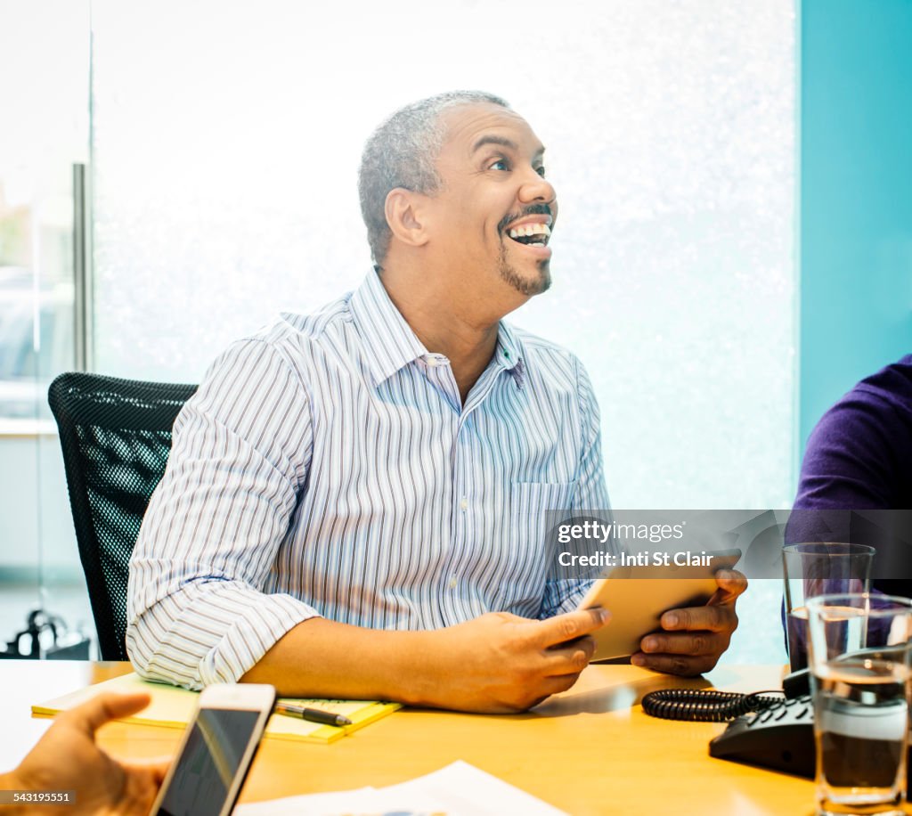 Businessman using digital tablet in office meeting