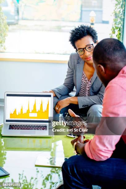 business people using laptop in office lobby - assessment graph stock pictures, royalty-free photos & images