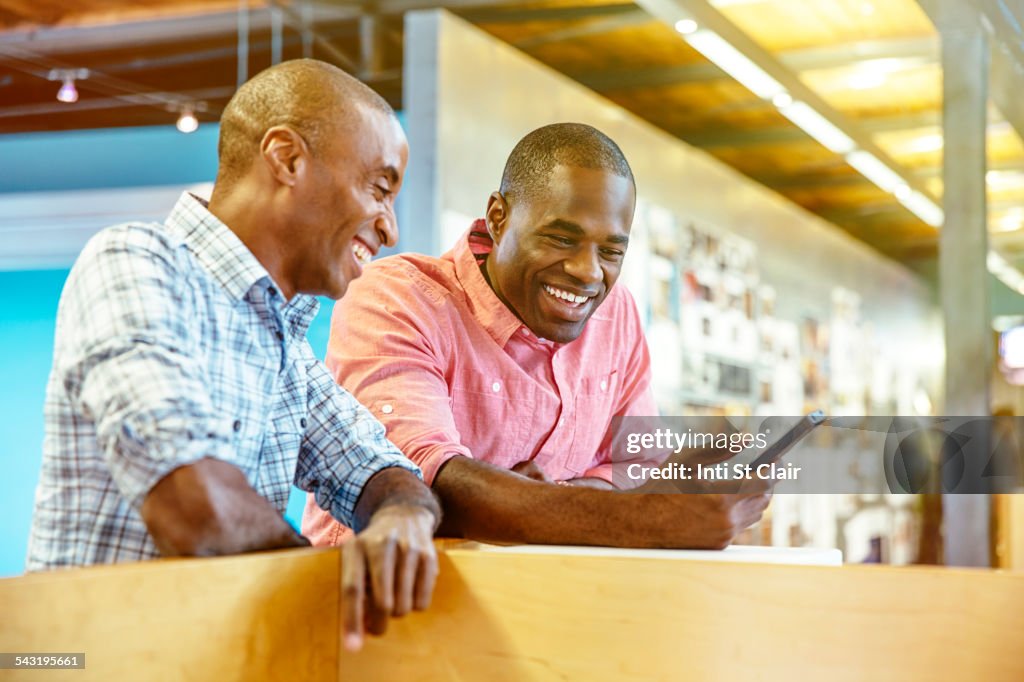 Businessmen using cell phone in office