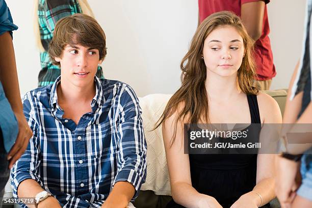 awkward curious teenage couple at party - girl blushing stock pictures, royalty-free photos & images